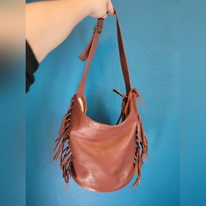 UGG brown leather fringe bucket bag with zipper. Dust bag included.